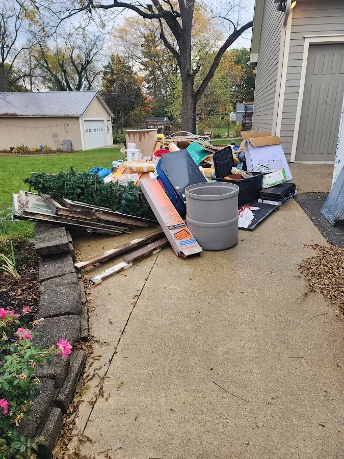 Dumpster being loaded with debris for Estate Cleanout Dumpster Rental in Mussey